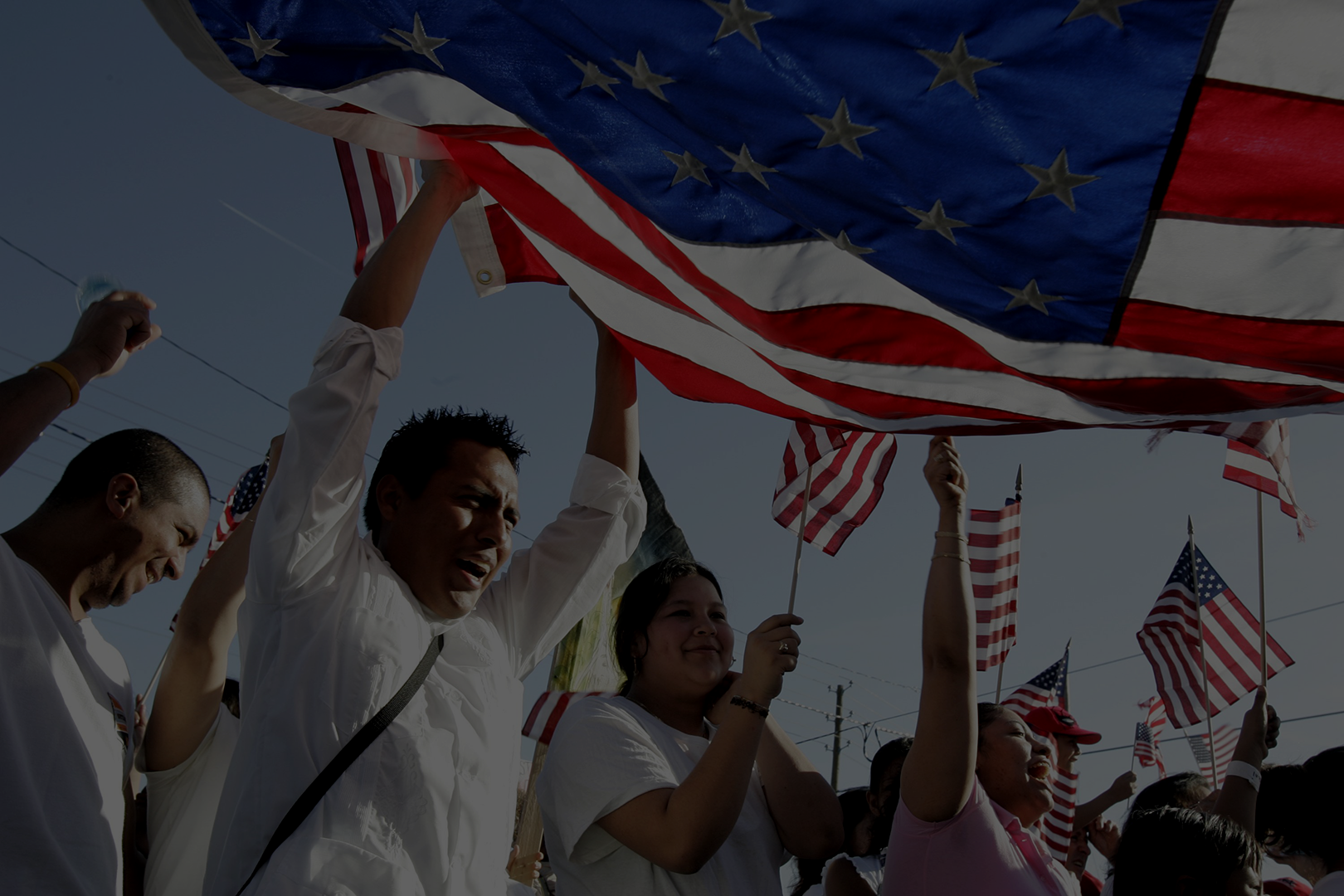 flag-and-immigrants-scaled-dark